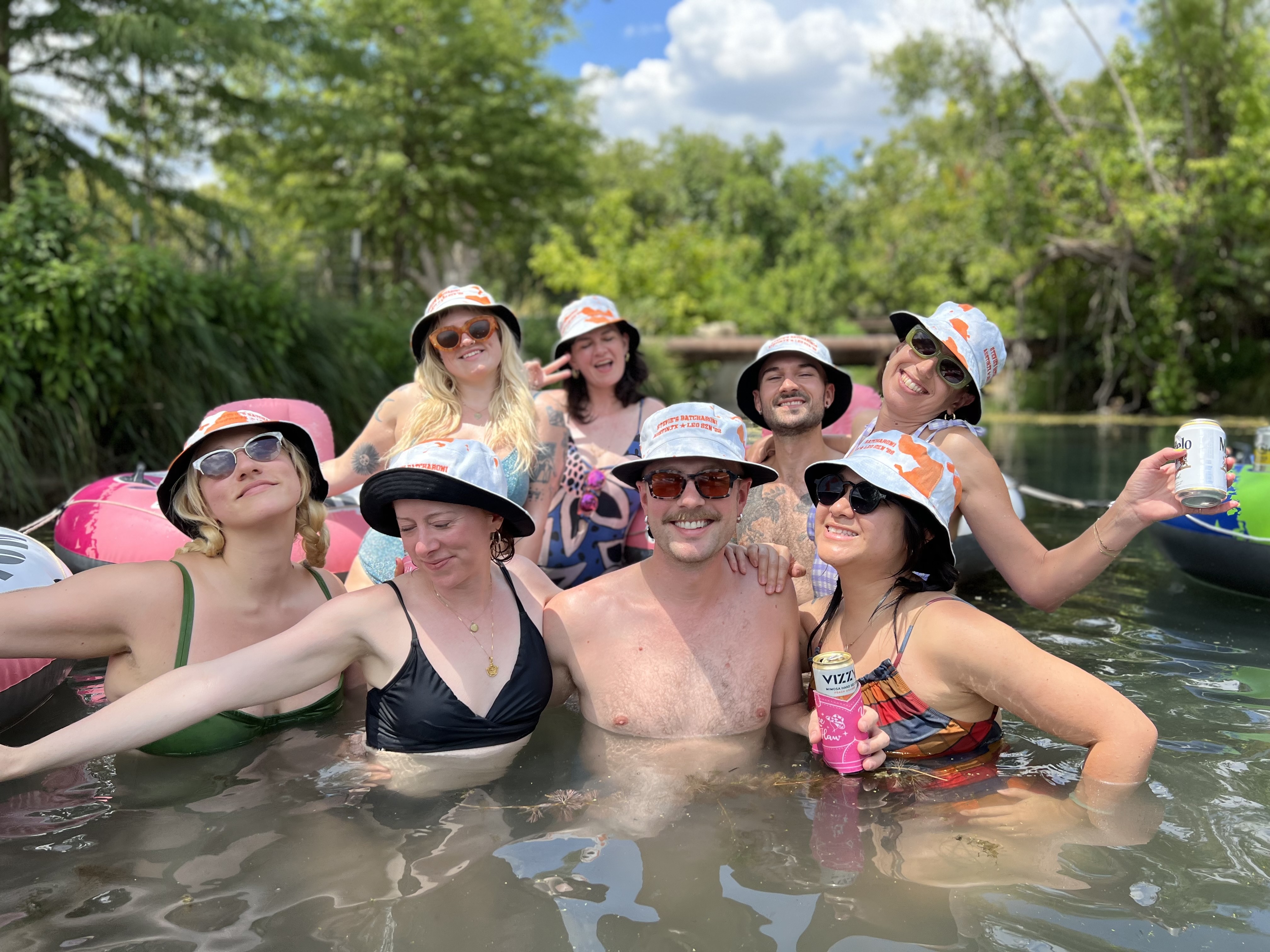 Group of friends laughing and tubing together on a fun Austin TX tour